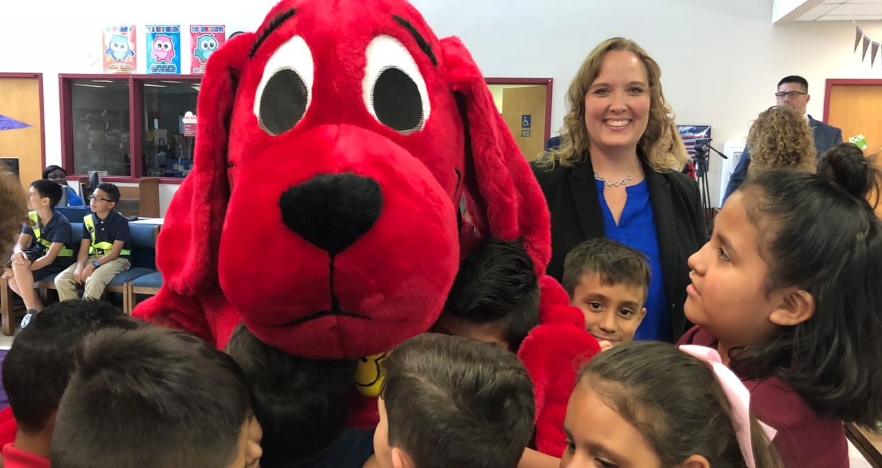 CEO Dr. Lisa Williams-Taylor with Clifford the Big Red Dog and children
