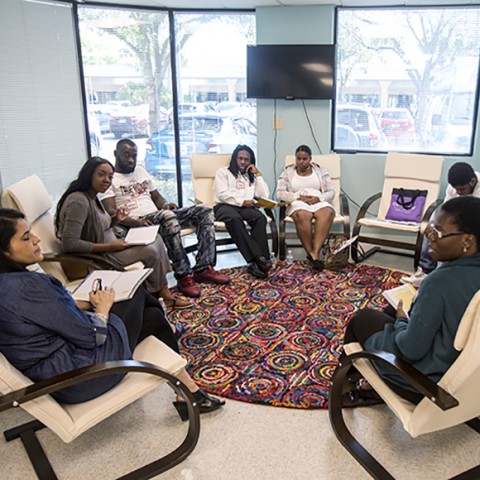 Pregnant women and their partners sit in a circle discussing their health and emotional needs as part of the CenteringPregnancy group prenatal care program in Palm Beach County, FL.
