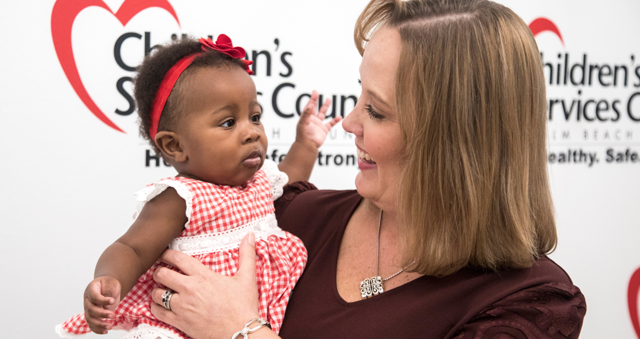 CEO Dr. Lisa Williams-Taylor holding a baby