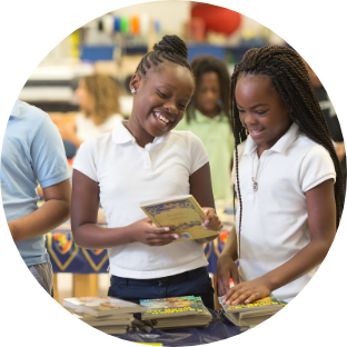 Girls sharing a book.