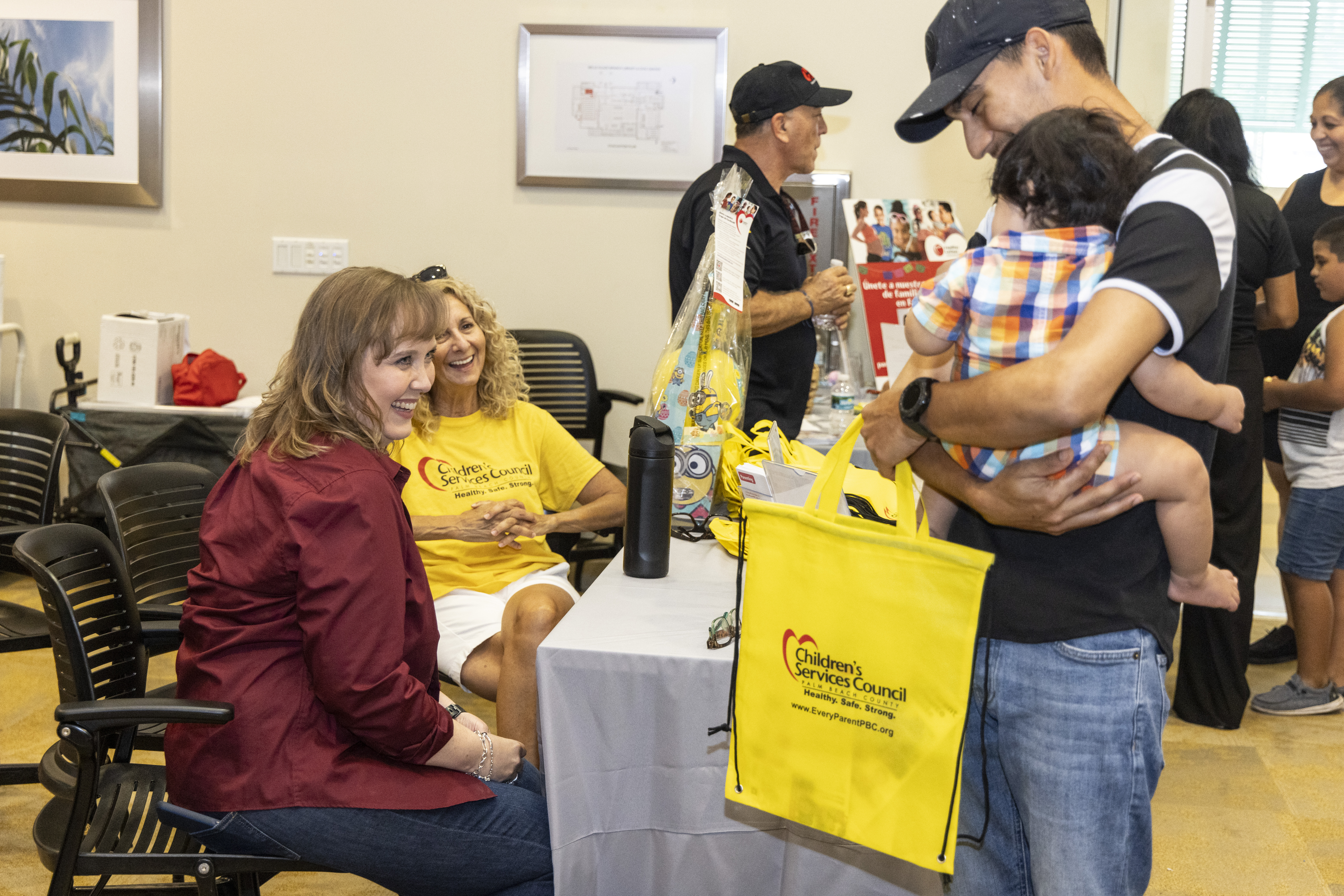 CEO meeting with local family members at event.