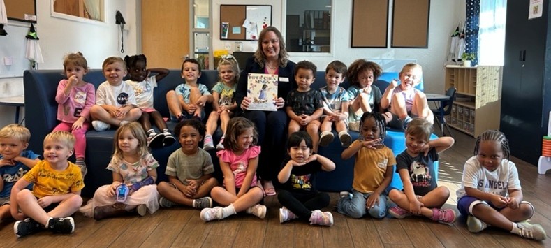 CEO reading to children in classroom.