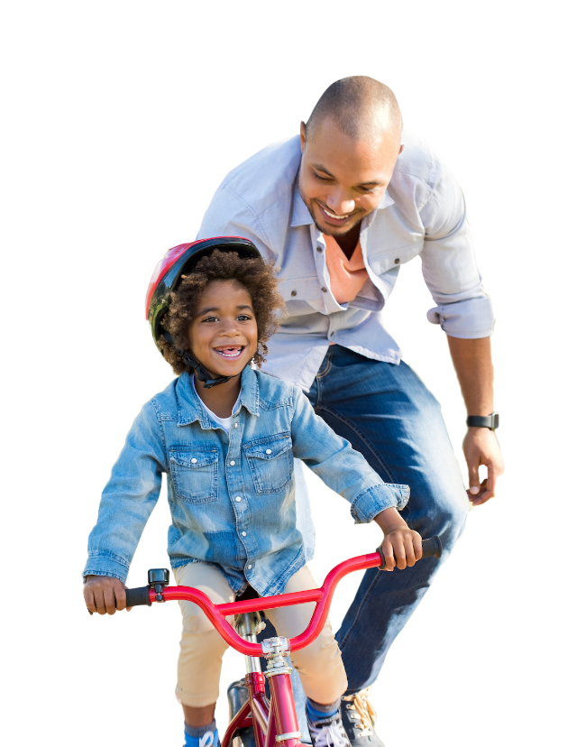 Father teaching child to ride a bike