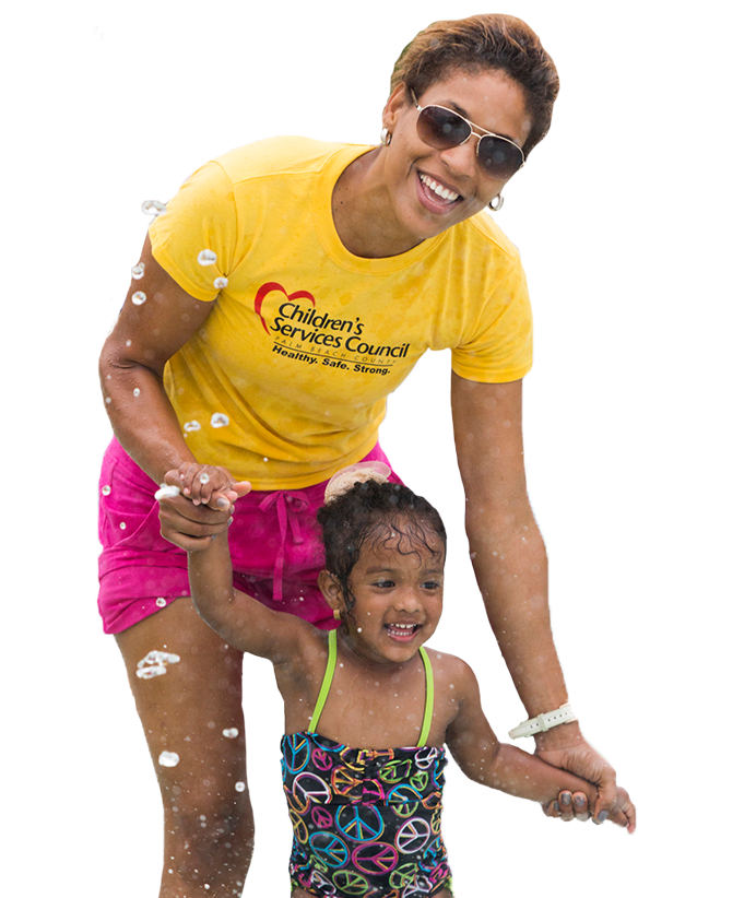 Mother with daughter splashing in pool.