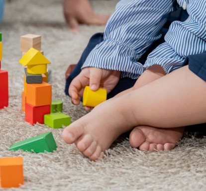 A baby playing with colorful blocks. 