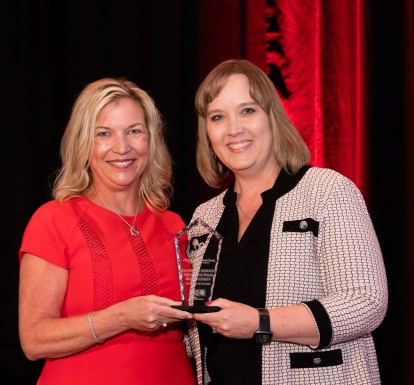 Dr. Laurie George, CEO of United Way Palm Beach County, handing the Champion for Children Award to Dr. Lisa Williams-Taylor, CEO of Children's Services Council of Palm Beach County.