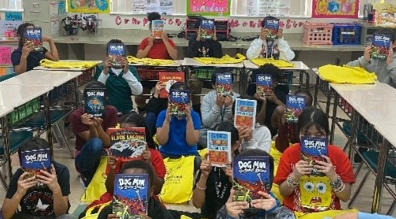 Children at Barton Elementary School hold up books they chose as part of Leadership Palm Beach County's 2025 Education Day reading event.