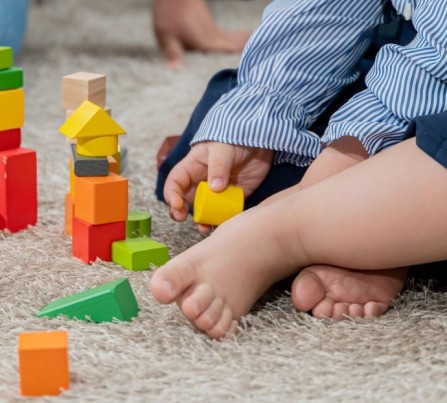 A baby playing with colorful blocks. 