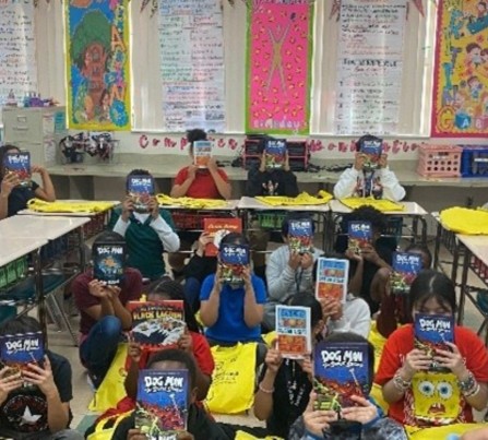 Children at Barton Elementary School hold up books they chose as part of Leadership Palm Beach County's 2025 Education Day reading event.