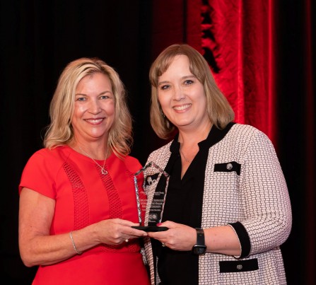 Dr. Laurie George, CEO of United Way Palm Beach County, handing the Champion for Children Award to Dr. Lisa Williams-Taylor, CEO of Children's Services Council of Palm Beach County.
