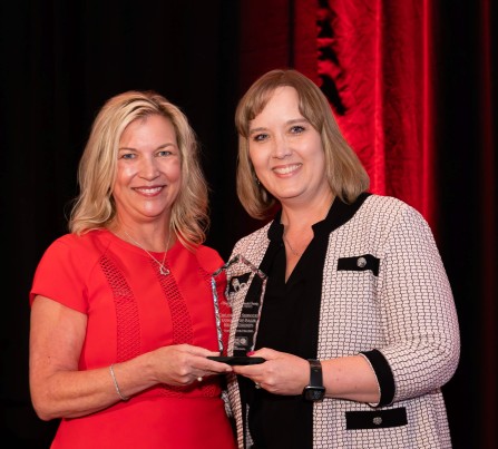 Dr. Laurie George, CEO of United Way Palm Beach County, handing the Champion for Children Award to Dr. Lisa Williams-Taylor, CEO of Children's Services Council of Palm Beach County.