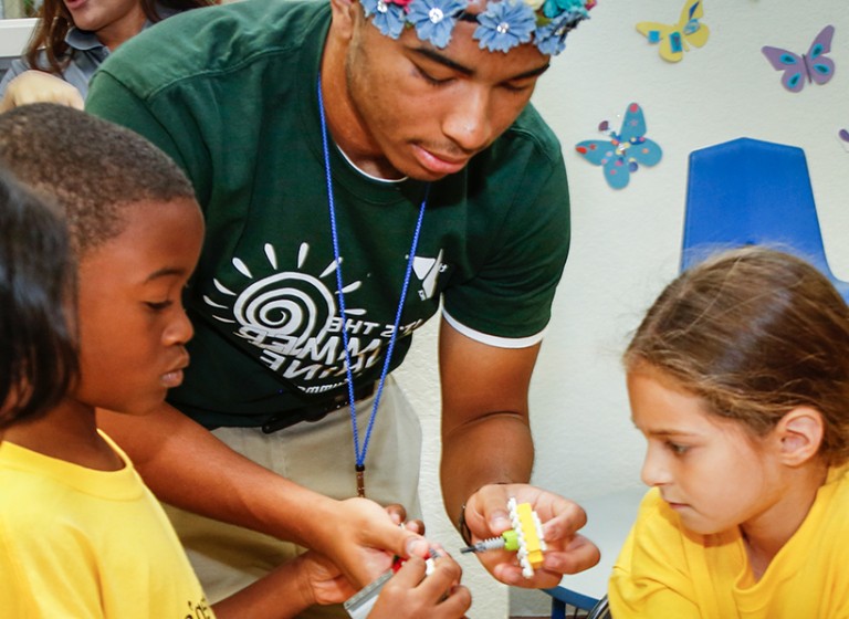 Child care counselor playing with children.