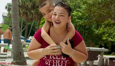 Son hugging mother at park.