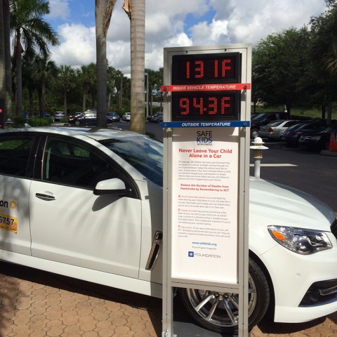 Car with external thermometer showing temperature outside as 94.3 degrees and inside the car as 131 degrees 