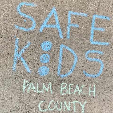 Safe Kids Palm Beach County drawn on sidewalk in chalk