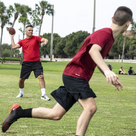 Father and son playing football.