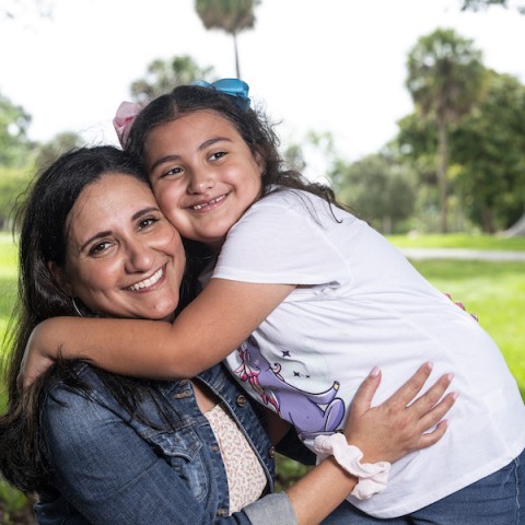 Mother and daughter hugging.