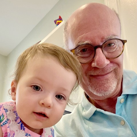 Granddaughter smiling with grandfather.