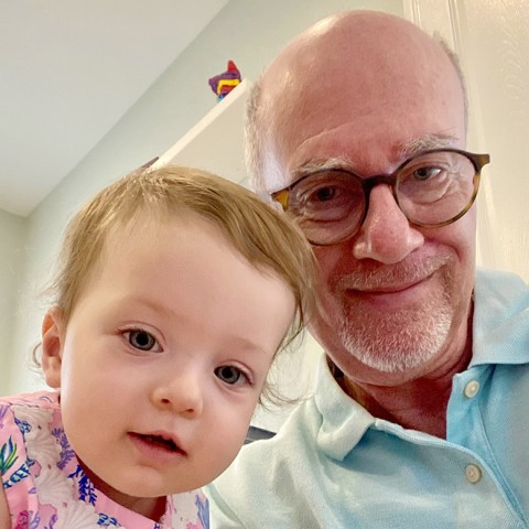 Granddaughter smiling with grandfather.