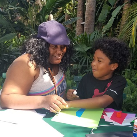 Grandmother and grandson making crafts.