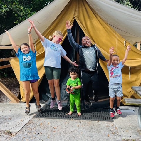 Kids jumping with hands in the air.