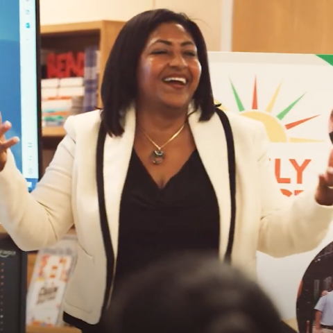 Woman presenting before a group of BRIDGES families