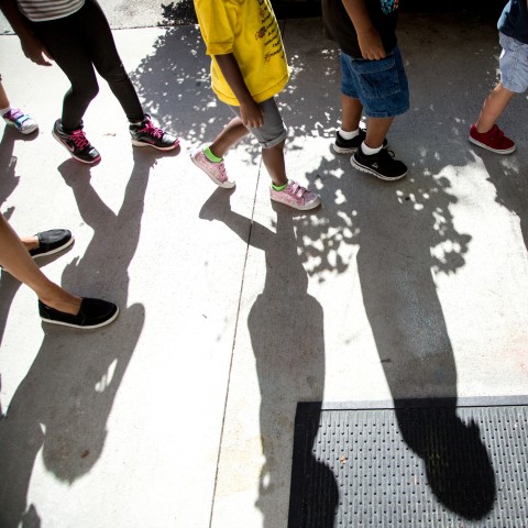 Children's feet walking in a line